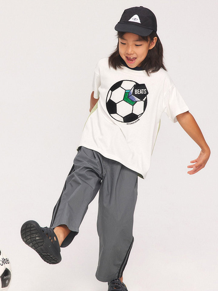 子供がサッカーテーマTシャツを着用して活動している様子